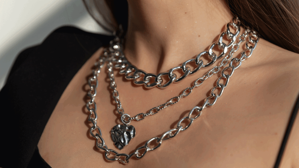 Girl In Black Dress Wearing Silver Color Layerd Necklace.